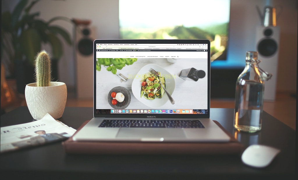 macbook on a desk showing a restaurant website