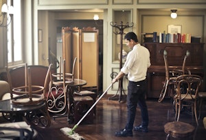 Employee cleaning restaurant lobby