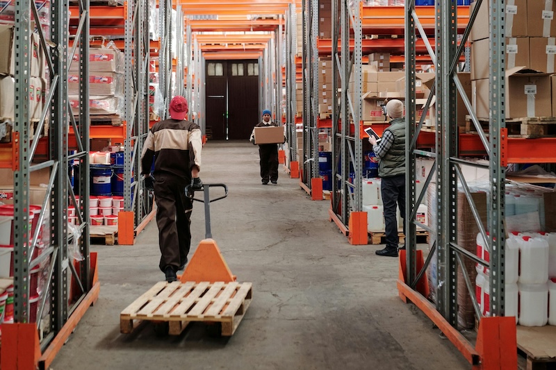 Warehouse workers using maintenance management software
